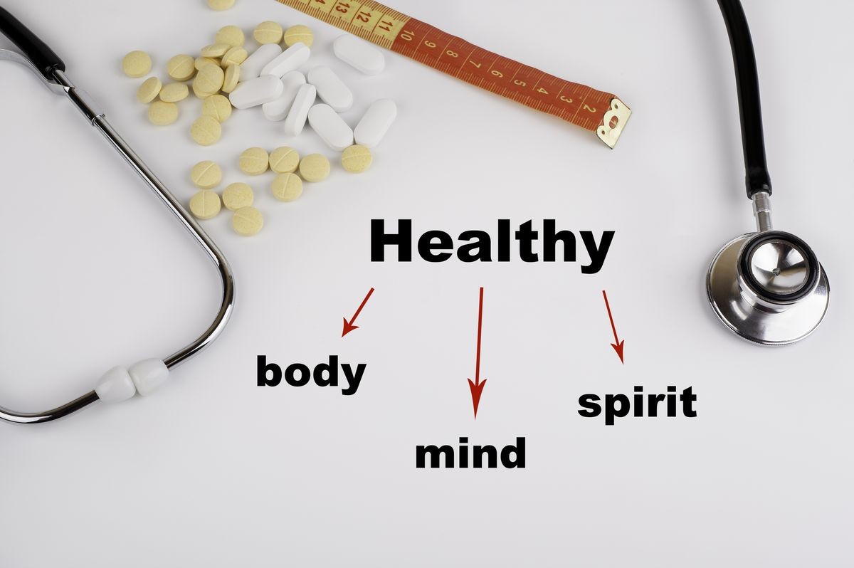Healthy concept. Body, Mind, and Spirit. White background with pills, stethoscope and tape measure